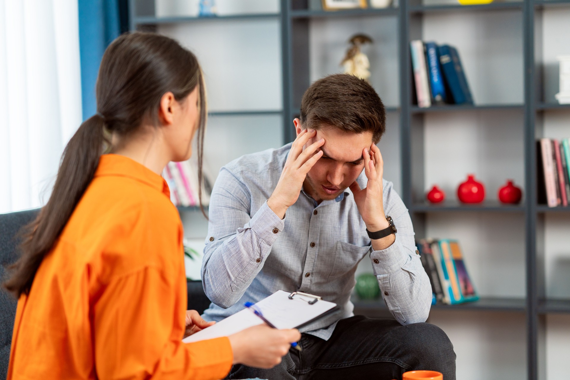 Shot of a young man having a therapeutic session with a psychologist